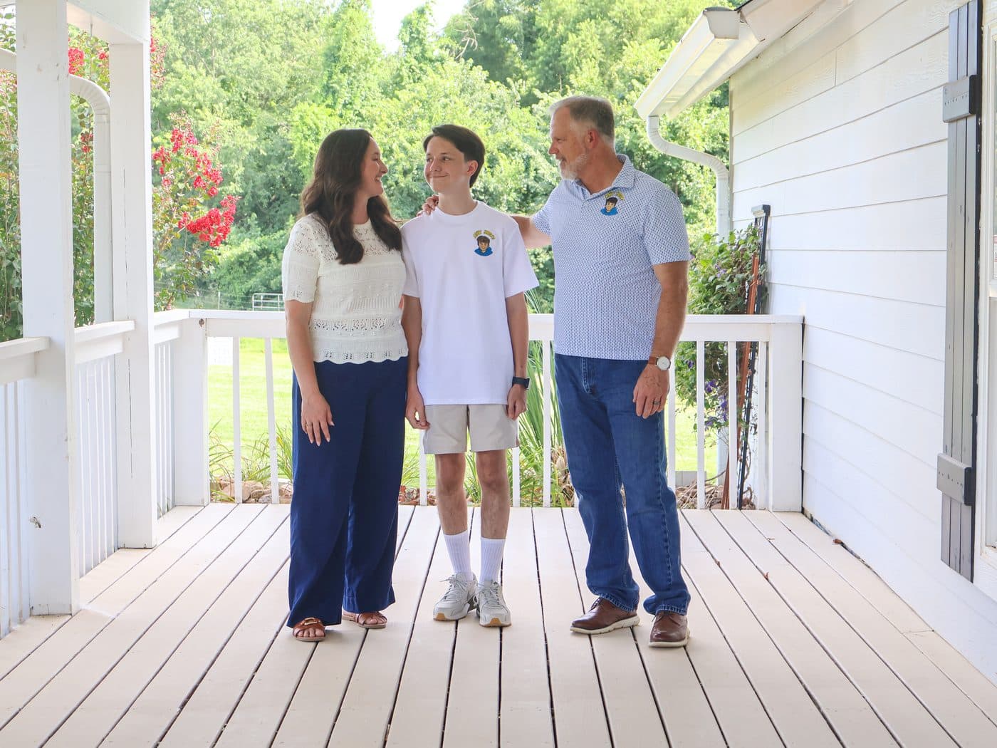 Rohmel, Khota, and Amanda together on the farmhouse porch